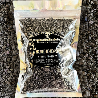 A sealed silver bag of Gory Dreadful Candle Co Prosecc-Ho-Ho-Ho Sizzling Room Salt Crystals with a holographic design and branding information on the label.